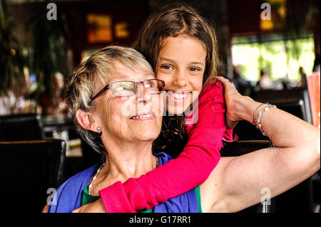 Portrait of girl with arms around grandmother Stock Photo