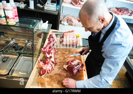 Butcher preparing meat in butcher's shop Stock Photo