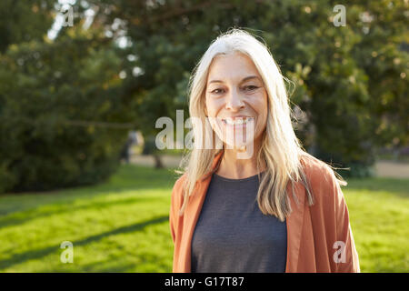 Portrait of grey haired senior woman looking at camera smiling Stock Photo