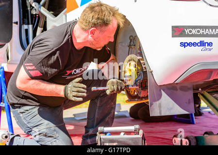 Emmaboda, Sweden - May 7, 2016: 41st South Swedish Rally in service depot. Crew working on rear brake disc on a white Citroen Ds Stock Photo