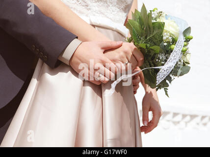 a married couple holds a wedding bouquet in the hands, not a face Stock Photo