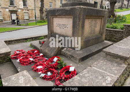 Poppy wreaths on the war memorial on The Hill on the A361 through Burford, Oxfordshire, UK Stock Photo