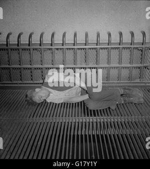 Homeless black man sleeping on a park bench New York City New York ...