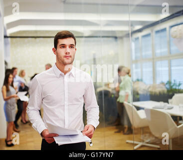 Man as a lawyer and consultant with peperwork on his hands in the office Stock Photo