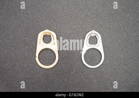 Ring pull cans opener on black metallic background Stock Photo