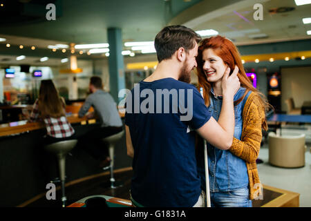 Couple hugging in snooker bar  on their date Stock Photo