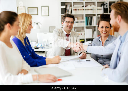 Agreement between company representatives at office table Stock Photo