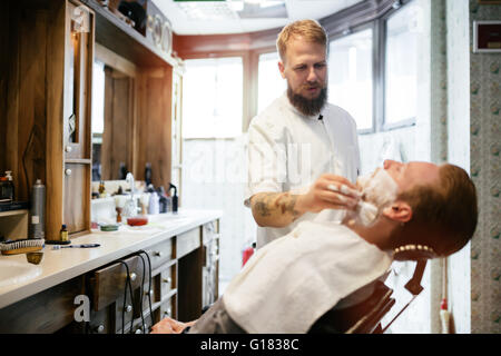 Hair mustache beard treatment in barber shop Stock Photo