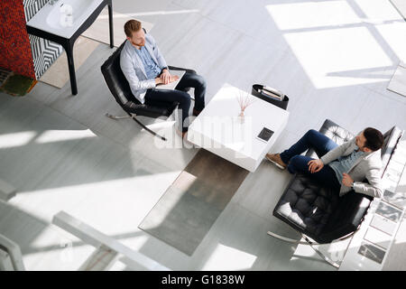 Business meeting in lobby by two businessmen Stock Photo