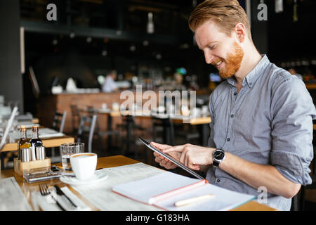 Businessman working while taking a break, no time to waste Stock Photo