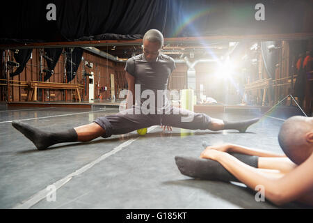 Dancers doing stretching exercise Stock Photo