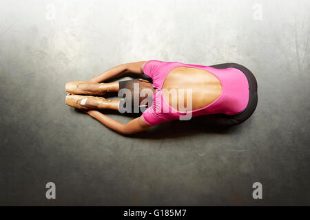Ballet dancer doing stretching exercise Stock Photo