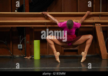 Dancer doing stretching exercise using barre Stock Photo