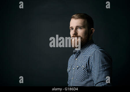 Red bearded man studio portrait on dark background Stock Photo