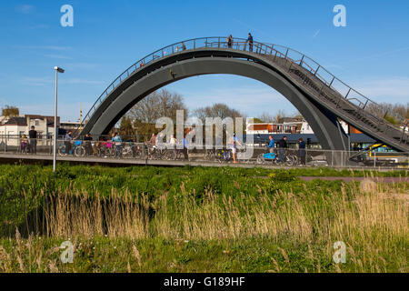 Cycle and pedestrian bridge, Melkwegbruk in Purmerend, North Holland, via a channel, arch bridge for pedestrians and cyclists Stock Photo