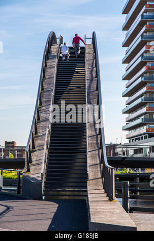 Cycle and pedestrian bridge, Melkwegbruk in Purmerend, North Holland, via a channel, arch bridge for pedestrians and cyclists Stock Photo