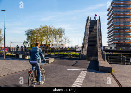 Cycle and pedestrian bridge, Melkwegbruk in Purmerend, North Holland, via a channel, arch bridge for pedestrians and cyclists Stock Photo