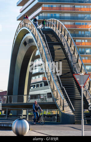 Cycle and pedestrian bridge, Melkwegbruk in Purmerend, North Holland, via a channel, arch bridge for pedestrians and cyclists Stock Photo