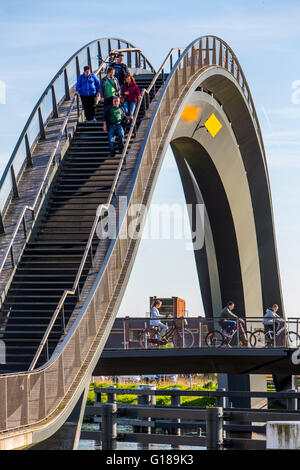 Cycle and pedestrian bridge, Melkwegbruk in Purmerend, North Holland, via a channel, arch bridge for pedestrians and cyclists Stock Photo