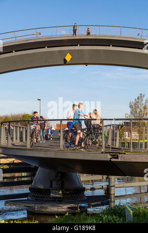 Cycle and pedestrian bridge, Melkwegbruk in Purmerend, North Holland, via a channel, arch bridge for pedestrians and cyclists Stock Photo