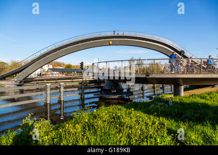 Cycle and pedestrian bridge, Melkwegbruk in Purmerend, North Holland, via a channel, arch bridge for pedestrians and cyclists Stock Photo