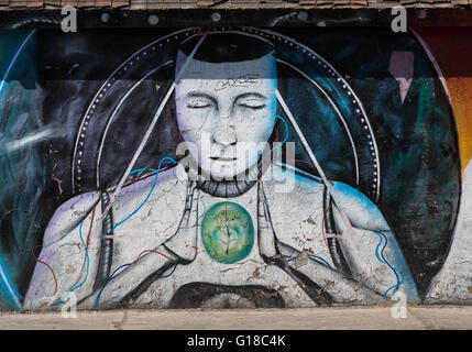 Urban art depicting man holding green globe in the Spanish colonial city of Santiago de Queretaro, Querétaro Mexico Stock Photo