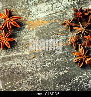 Food frame with heap of Star Anise on vintage black surface. View from above. Space for your text. Square composition. Stock Photo