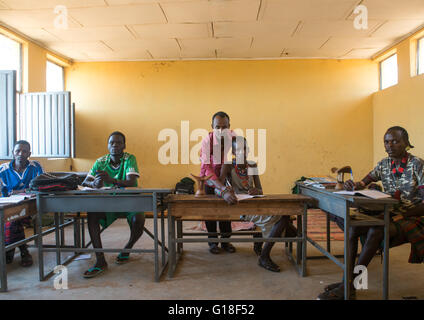 Hamer tribe teenage boys in classroom with their teacher, Omo valley, Turmi, Ethiopia Stock Photo