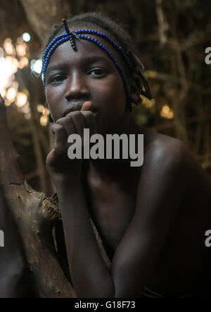 Circumcised boy from the dassanech tribe with his traditional wooden ...