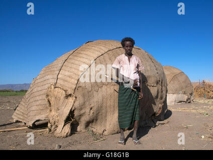 Afar tribe man with his guile knife in front of his hut, Afar region, Afambo, Ethiopia Stock Photo