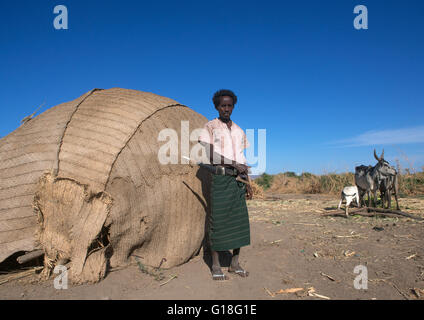 Afar tribe man with his guile knife in front of his hut, Afar region, Afambo, Ethiopia Stock Photo