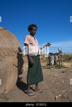 Afar tribe man with his guile knife in front of his hut, Afar region, Afambo, Ethiopia Stock Photo