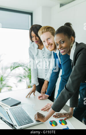 Exchange of thoughts during business meeting in a nice office by black and white colleagues Stock Photo