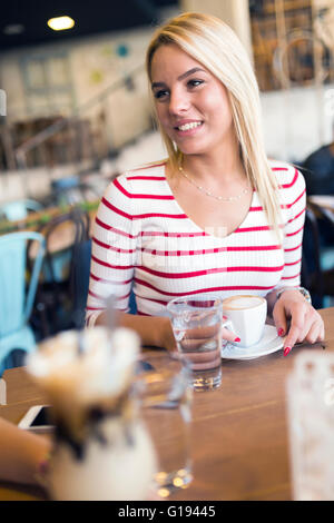Beautiful woman enjoying beverages in nice cafe Stock Photo