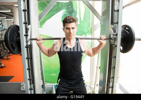 Handsome man training in gym to stay fit and strong Stock Photo