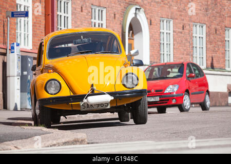 Helsinki, Finland - May 7, 2016: Old yellow Volkswagen beetle is parked on a roadside, front view Stock Photo
