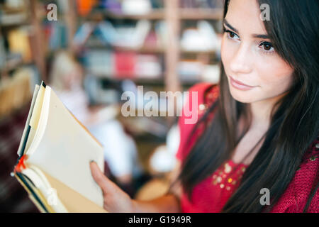 Beautiful woman reading book and preparing for exam Stock Photo
