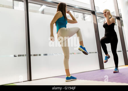 Beautiful women stretching and exercising in fitness club Stock Photo