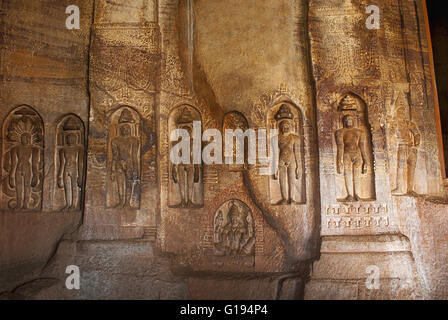 Cave 4 : Jaina Tirthankara images engraved on the inner pillars and walls. There are idols of Yakshas, Yakshis, Padmavati and ot Stock Photo