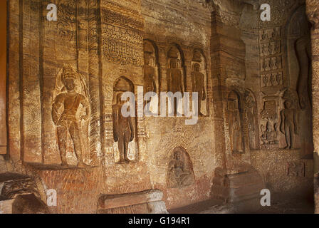 Cave 4 : Jaina Tirthankara images engraved on the inner pillars and walls. There are idols of Yakshas, Yakshis, Padmavati and ot Stock Photo