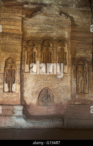 Cave 4 : Jaina Tirthankara images engraved on the inner pillars and walls. There are idols of Yakshas, Yakshis, Padmavati and ot Stock Photo