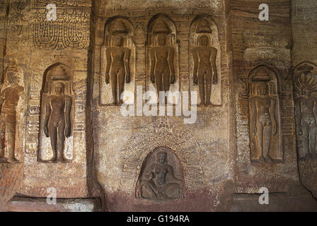 Cave 4 : Jaina Tirthankara images engraved on the inner pillars and walls. There are idols of Yakshas, Yakshis, Padmavati and ot Stock Photo