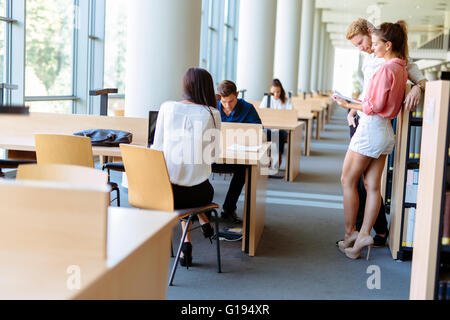 Young students studying together in a library Stock Photo