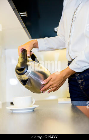 https://l450v.alamy.com/450v/g194yy/closeup-of-hot-water-being-poured-out-of-the-kettle-in-a-modern-kitchen-g194yy.jpg