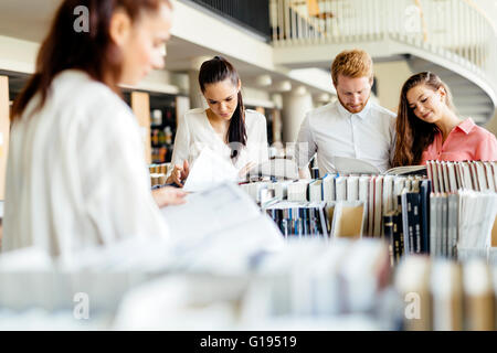 Group of students studying in library and reading books Stock Photo