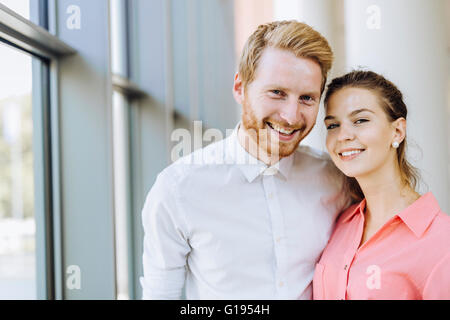 Beautiful colleagues in business smiling and being close to each other. Sincere emotions Stock Photo