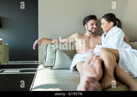 Lovely couple relaxing at a wellness center, laying in a rob and towel Stock Photo