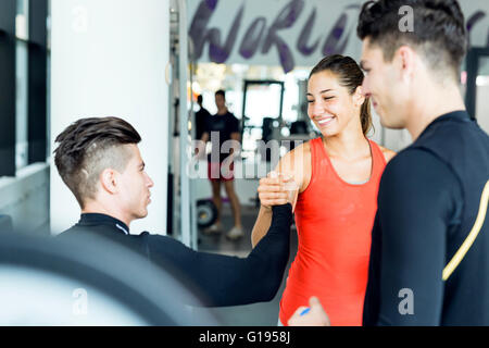 Group of positive young people shaking hands and talking happily Stock Photo