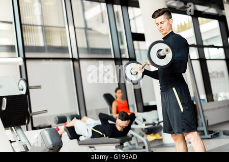 Young handsome man training in a fitness center Stock Photo