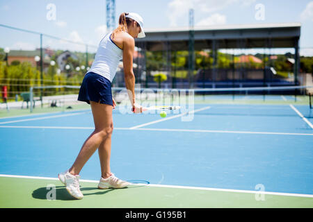 Beautiful female tennis player serving outdoor Stock Photo